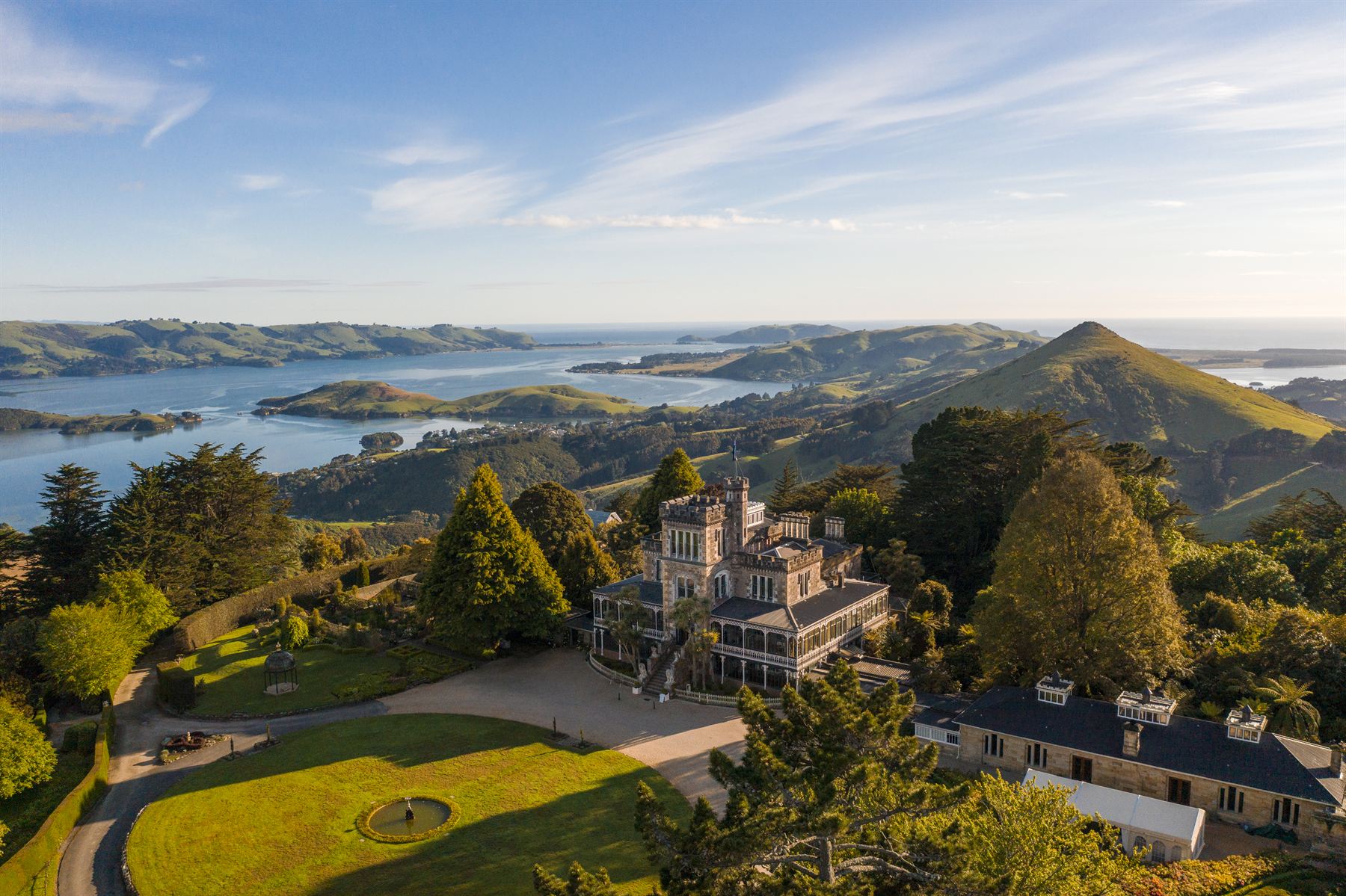 Larnach Castle and its grounds from the air, with the Otago Harbour beyond