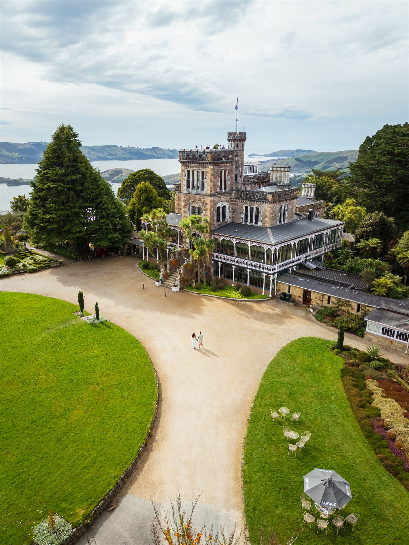 The circular lawn and driveway in front of the castle, with garden umbrellas out