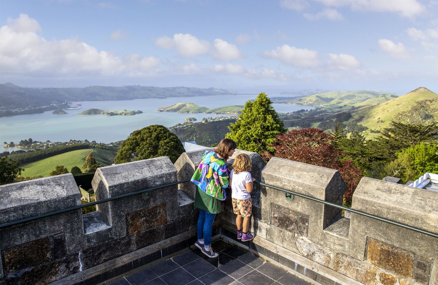 Visitors looking out over the harbour from the castle battlements
